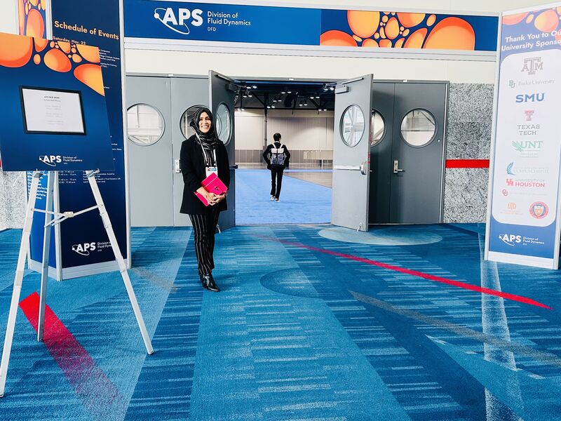 Shomi Aktar at the entrance to the 2025 APS Division of Fluid Dynamics meeting.